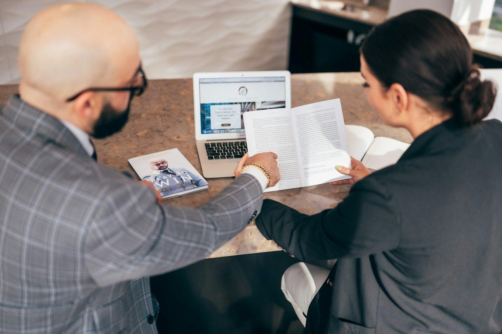 A Hartanah Makmur Realty negotiator taking a client through a cash-to-close cost sheet at the firm's Jalan Ampang office