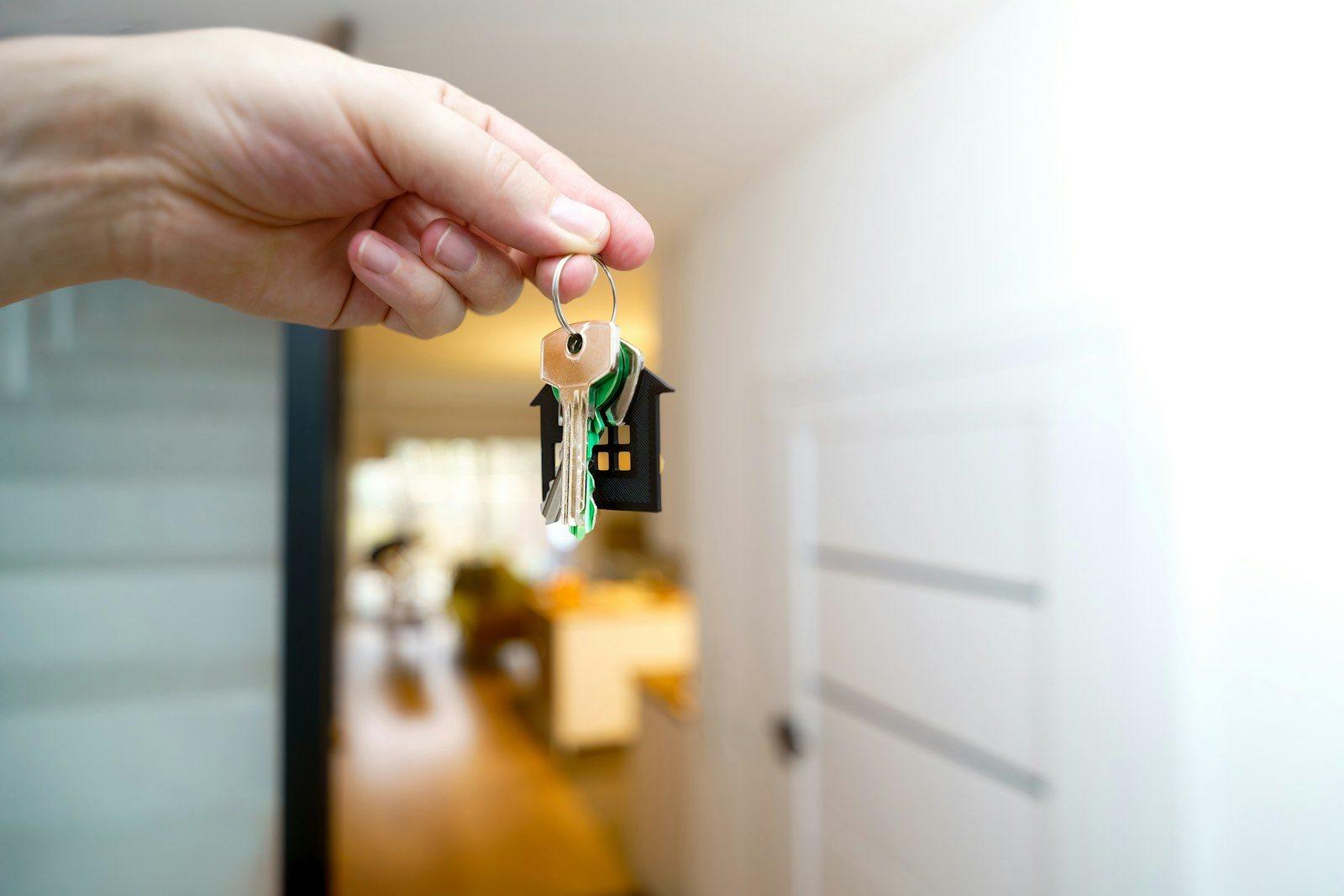 Keys being handed across a table at the completion of a property transaction